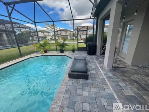 A pool with a bench and a glass wall.