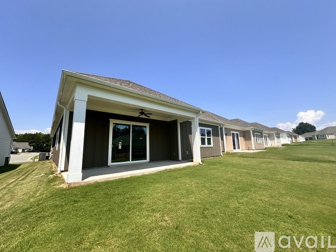 A house with a lawn in front is available for rent.