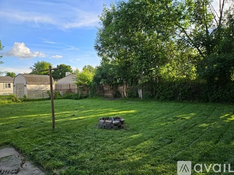 A backyard with a lawn and trees.