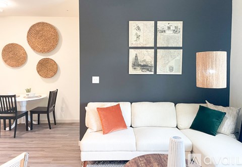 A living room with a white couch and a wooden coffee table.