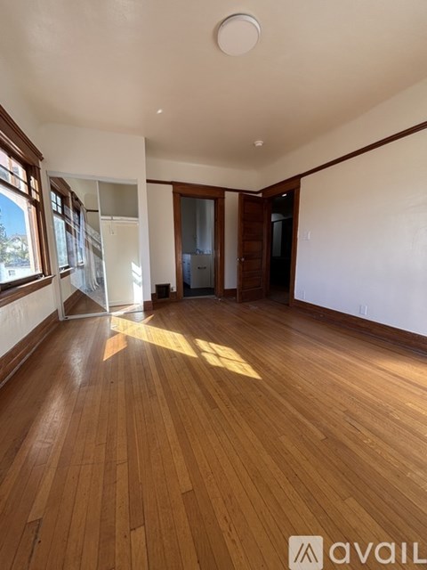 A room with wooden floors and a white ceiling.