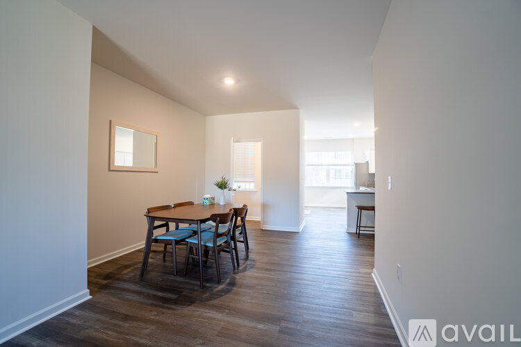 A dining room with a wooden table and chairs.