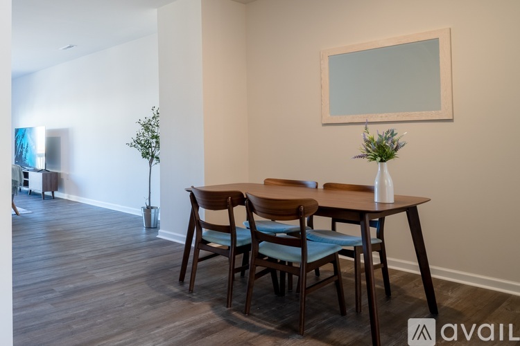 A dining room with a table and chairs.