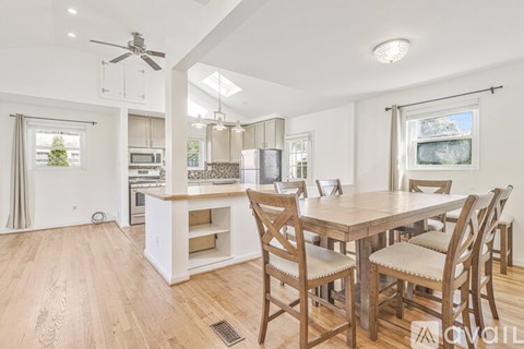 A modern kitchen with a dining table and chairs.