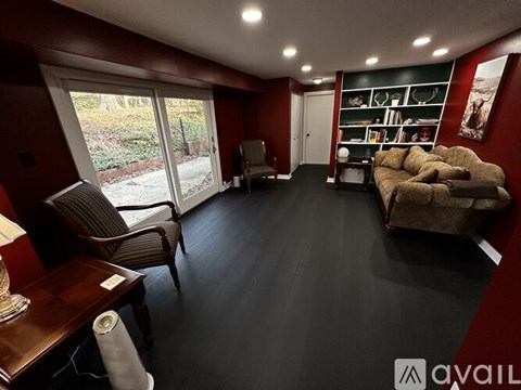 A living room with a brown couch and a chair.
