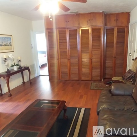 A room with a wooden floor and a ceiling fan.