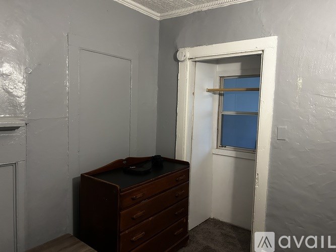 A room with a desk and a window.