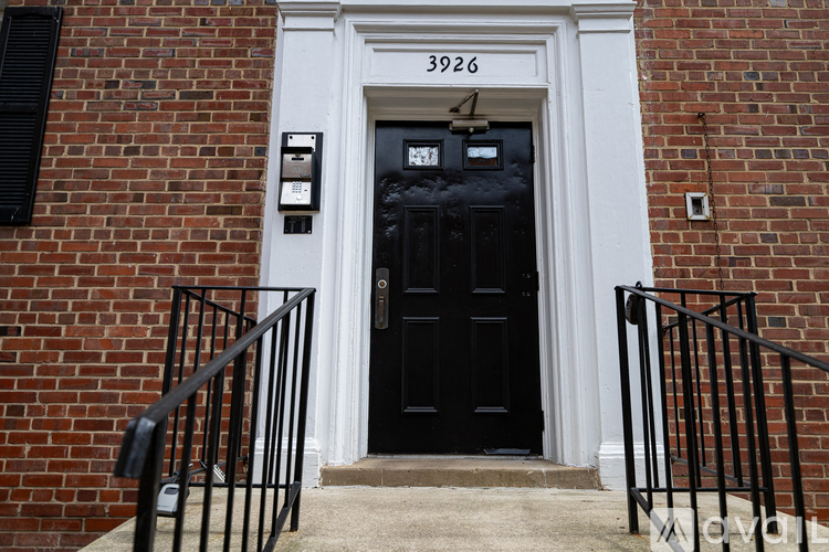 A black door with a white frame and a number 3926 above it.