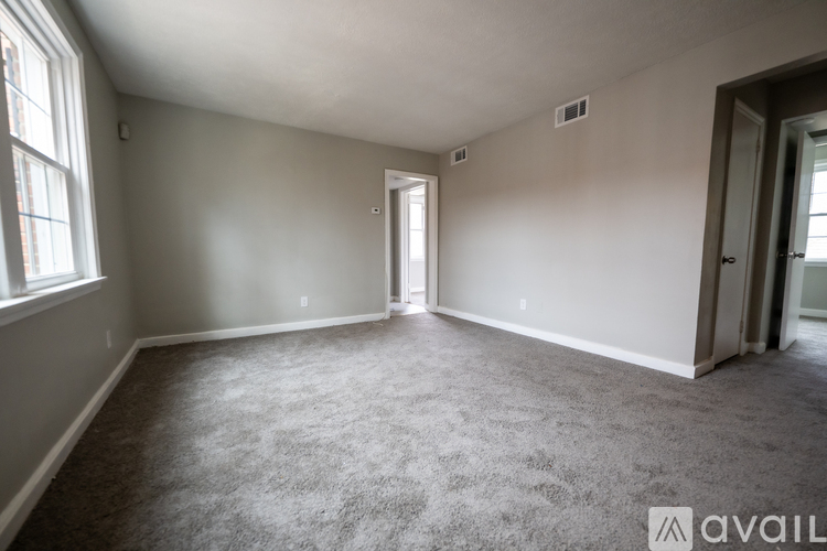 A room with carpeted floor and a window.