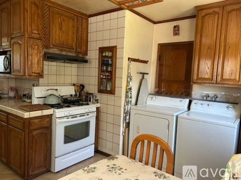 A kitchen with wooden cabinets and white appliances.