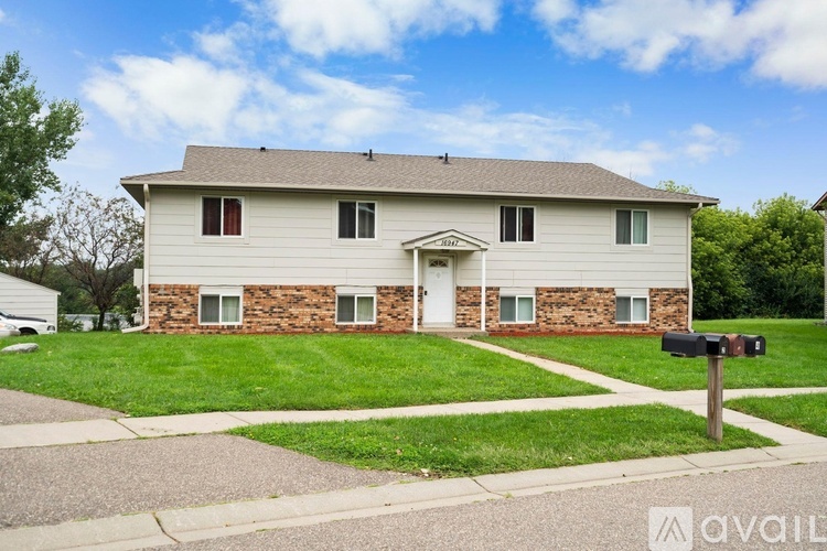 A house with a brick wall and a white door is for sale.