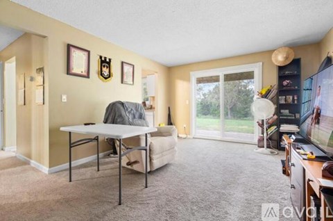 A living room with a grey sofa and a white table.
