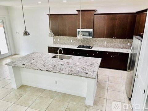 A kitchen with a granite countertop and a sink.