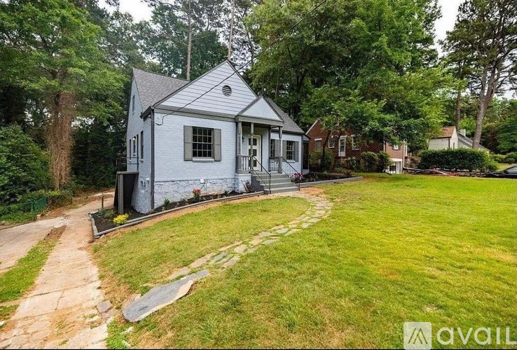 A small house with a porch and a yard.