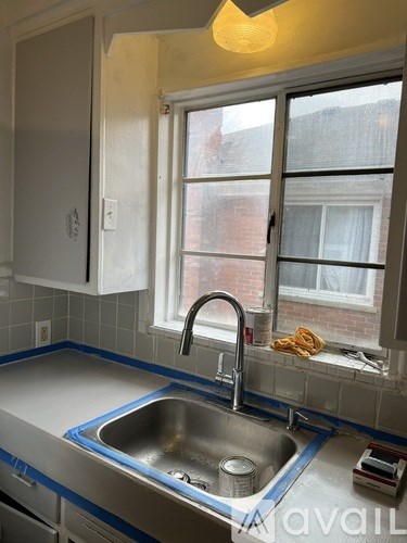 A kitchen with a sink and a window.