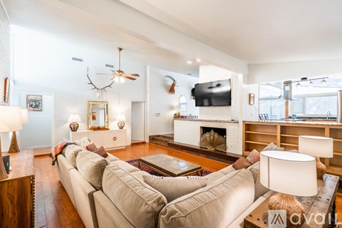 A living room with a large couch and a television.
