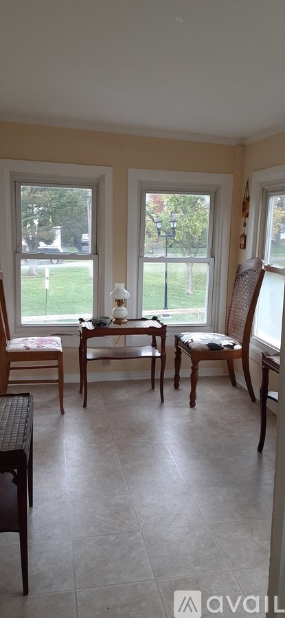 A living room with a table and chairs.