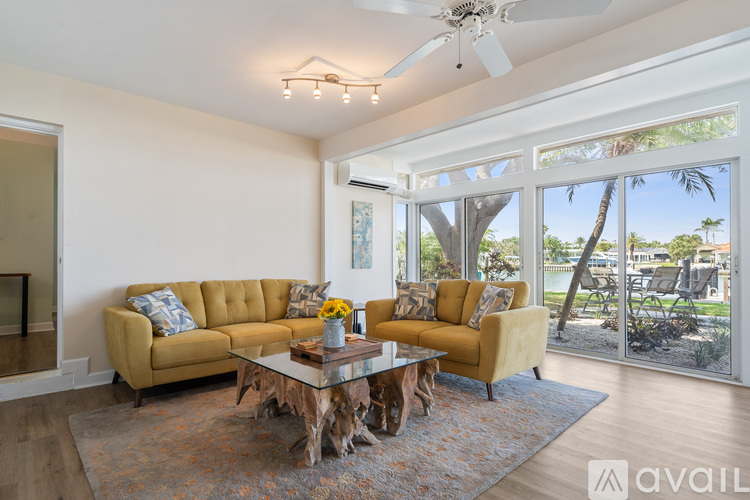 A living room with a tan couch and a coffee table.