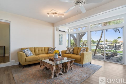 A living room with a tan couch and a coffee table.