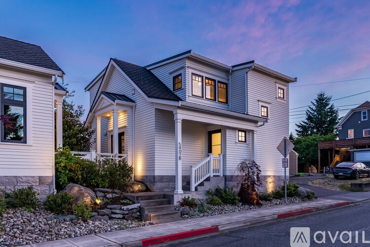 A house with a front yard and a car parked in the driveway.