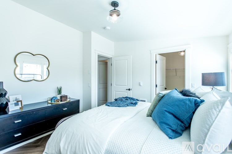 A bedroom with a large bed and a mirror on the wall.