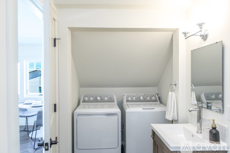 A small laundry room with a washer and dryer.