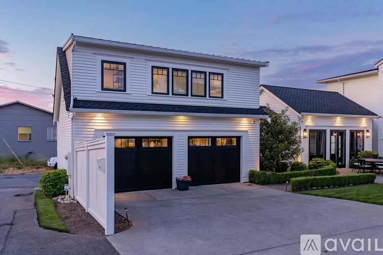 A house with a garage and a driveway in front.
