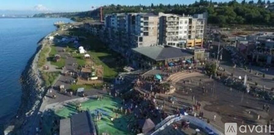 A beachside area with a large body of water and apartment buildings.