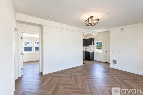 A kitchen with black cabinets and a white countertop.
