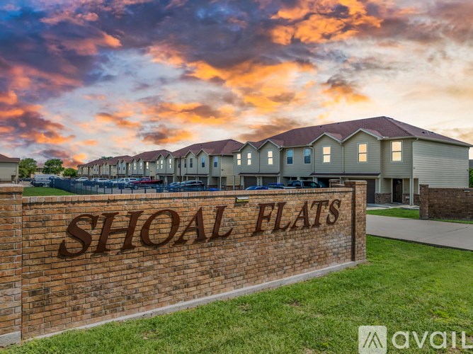 Shoal Flats is a residential area with houses and a sign in front.