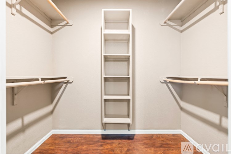 A room with a ladder in the middle and shelves on the sides.