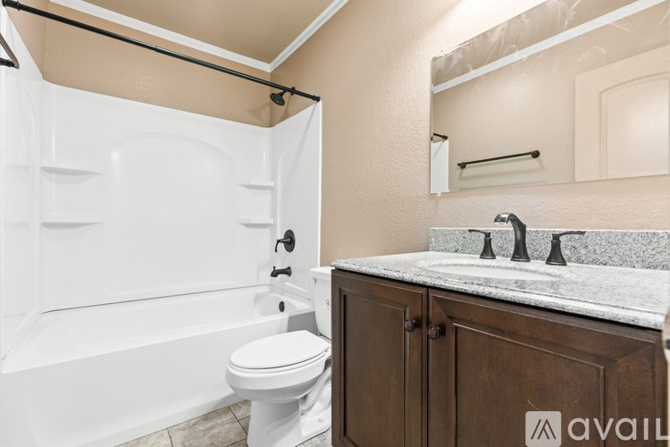 A bathroom with a white tub, toilet, and sink.