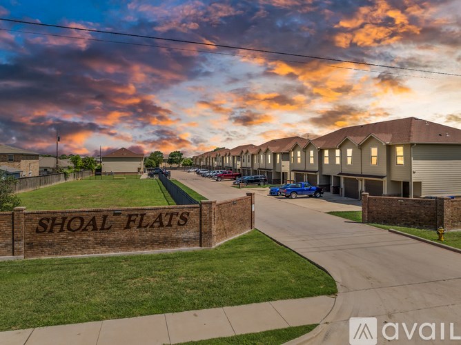 Shoal Flats is a residential area with houses and a sign in front.