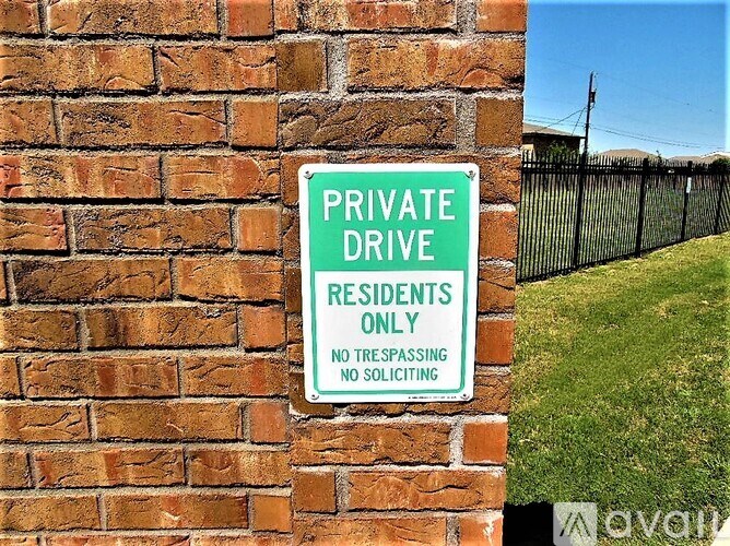 A sign on a brick wall that says Private Drive Residents Only.