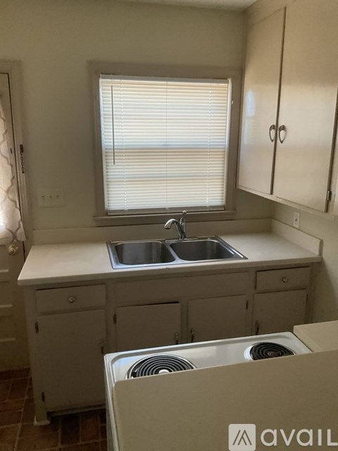 A kitchen with a sink and a window.