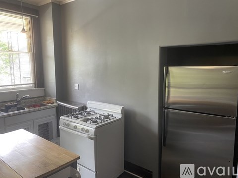 A kitchen with a white stove and a wooden table.