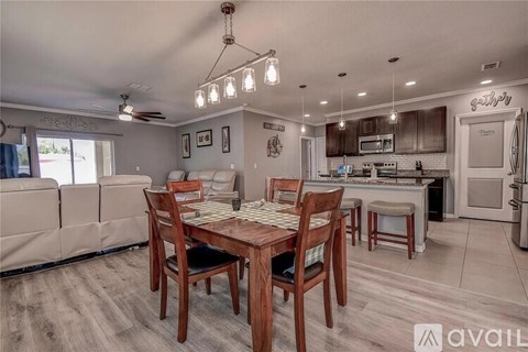 A dining room with a wooden table and chairs.