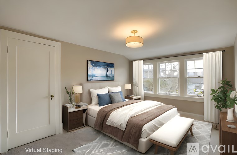 A bedroom with a bed, nightstand, and a painting on the wall.