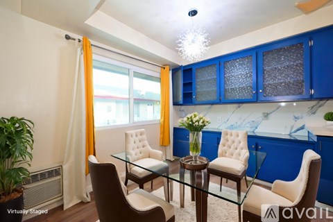 A dining room with a glass table and chairs.