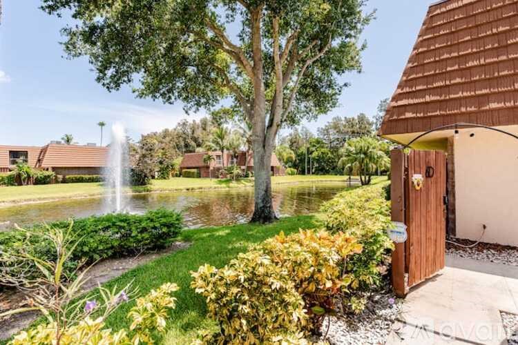 A bathroom with a white sink and a white toilet.