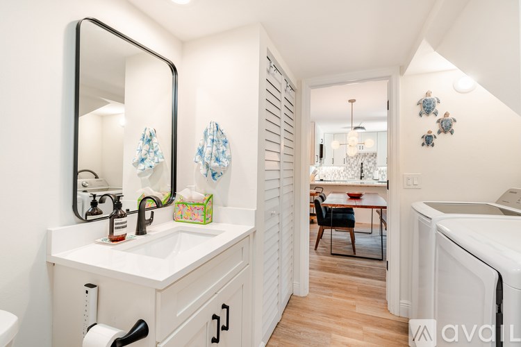 A white front loading washing machine and dryer in a laundry room.