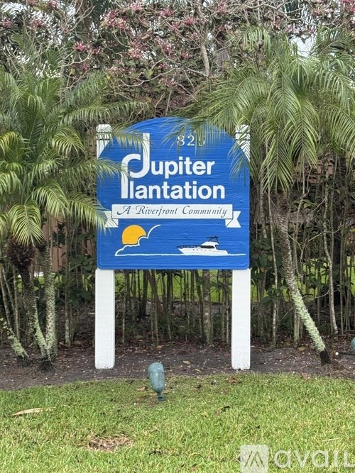 A bathroom with a toilet, sink, and mirror.