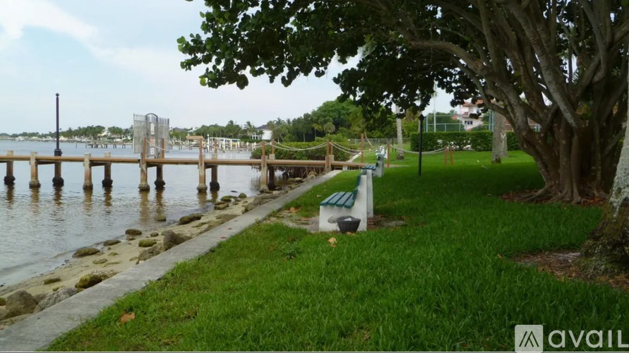 A patio with a table and chairs is lit by outdoor lights.