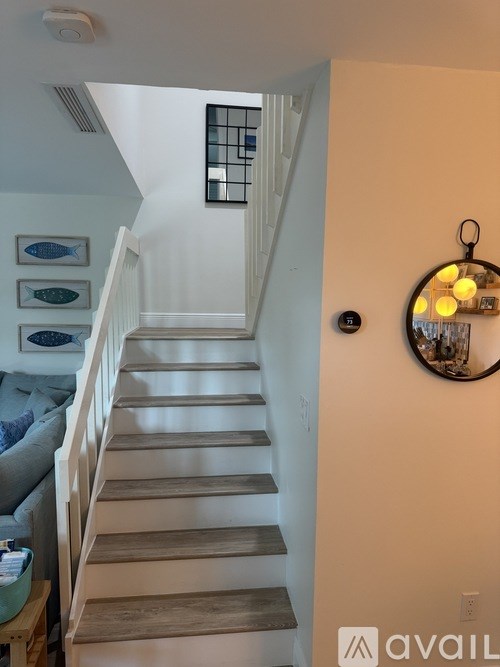 A staircase with a light on the wall.