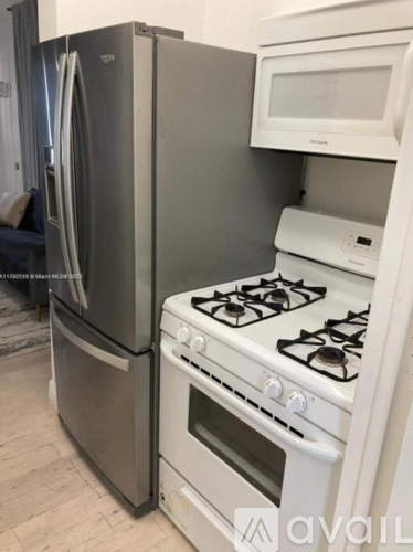 A white gas stove with a white oven and a white microwave above it.