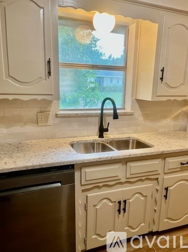 A kitchen with a sink and a window.