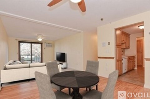 A living room with a table and chairs and a television.
