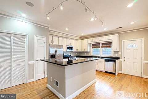 A room with a wooden floor and white walls.