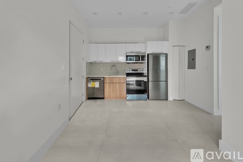 A kitchen with a refrigerator, oven, and microwave.
