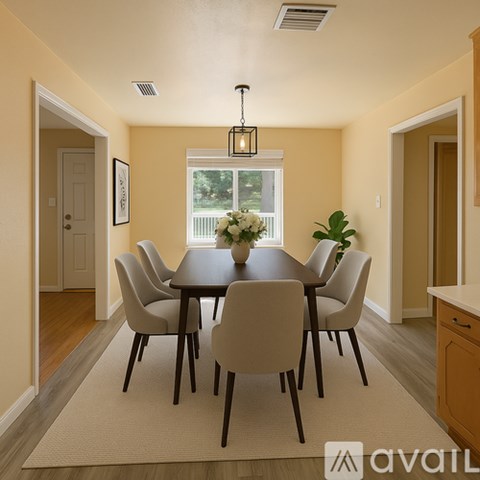 A dining room with a table set for six.